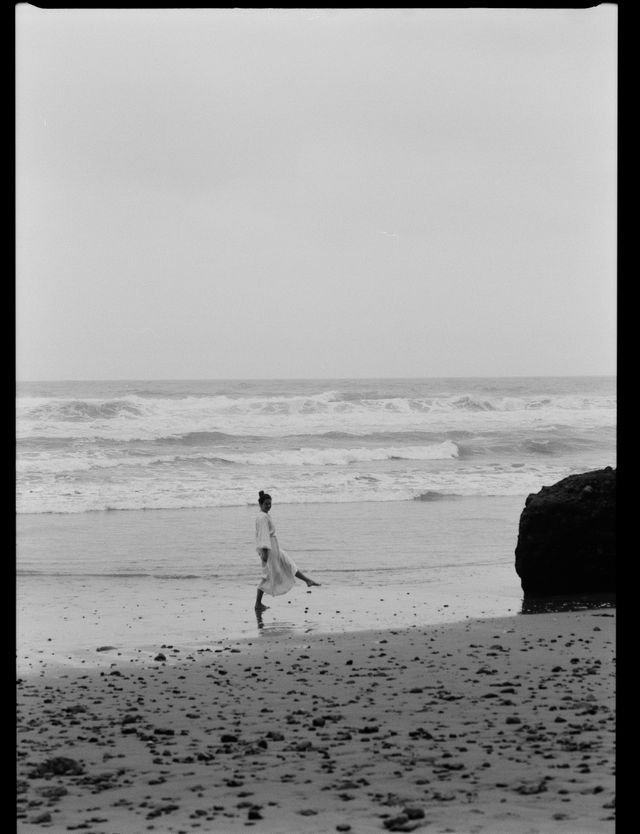 Webbie stepping forward on a beach in black and white